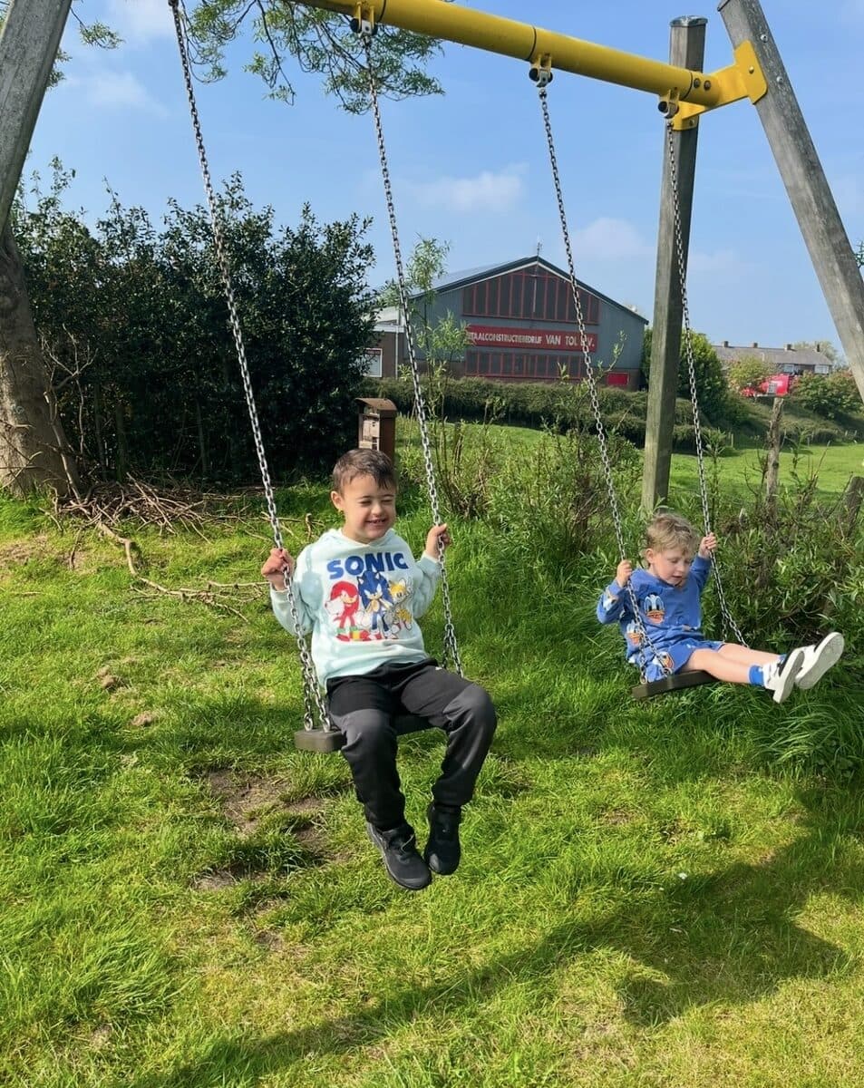 Twee kinderen op de schommels in het park